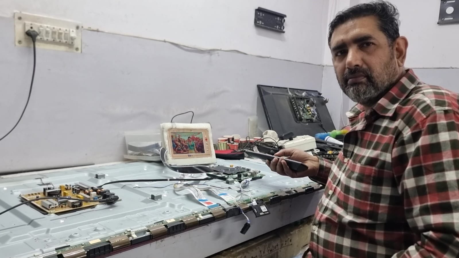 Illustration of a repair workbench with a circuit board, multimeter and tools